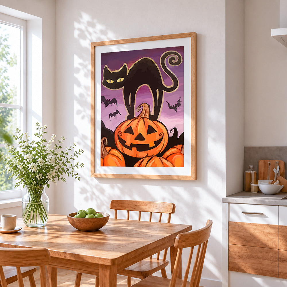 Black cat silhouette with pumpkins cross stitch artwork displayed on wall as home decor