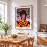 Black cat silhouette with pumpkins cross stitch artwork displayed on wall as home decor