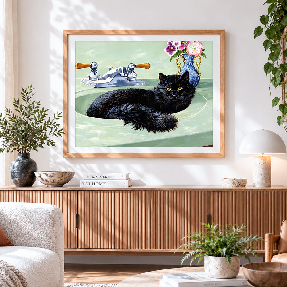Finished black cat sitting in a green sink cross stitch artwork displayed
