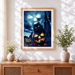 Finished black cat sitting on glowing jack-o'-lantern cross stitch artwork displayed