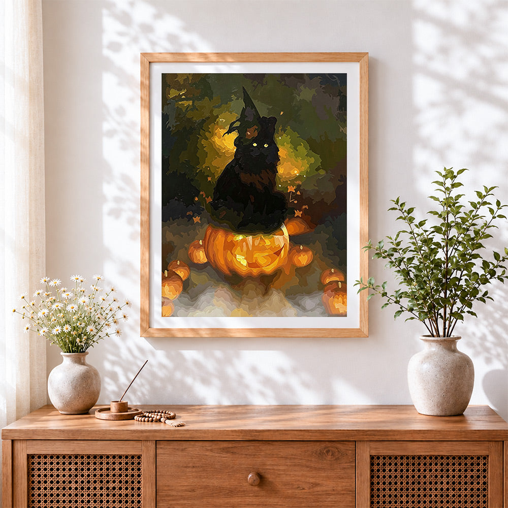 Finished black cat sitting on glowing pumpkin cross stitch artwork displayed