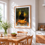 Black cat sitting on glowing pumpkin cross stitch artwork displayed on wall as home decor