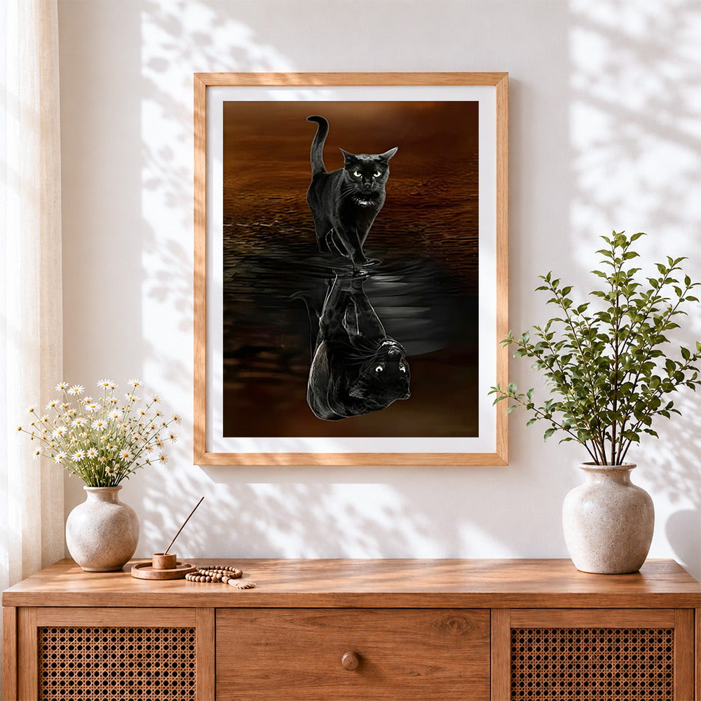 Finished black cat water reflection cross stitch artwork displayed