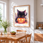 Black cat with glowing pumpkin cross stitch artwork displayed on wall as home decor