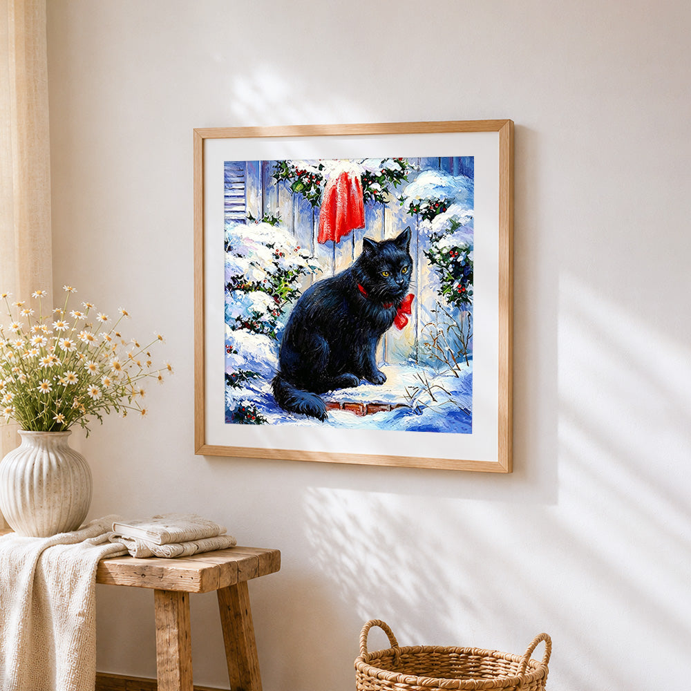 Black cat with red bow in the snow cross stitch artwork displayed on wall as home decor