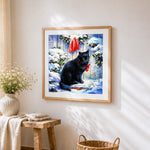 Black cat with red bow in the snow paint by numbers artwork displayed on wall as home decor
