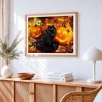Black cats and jack-o'-lanterns in autumn leaves cross stitch artwork displayed on wall as home decor