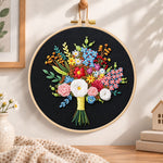 Black fabric flower bouquet embroidery hoop wall art displayed as warm and cosy handmade home decor