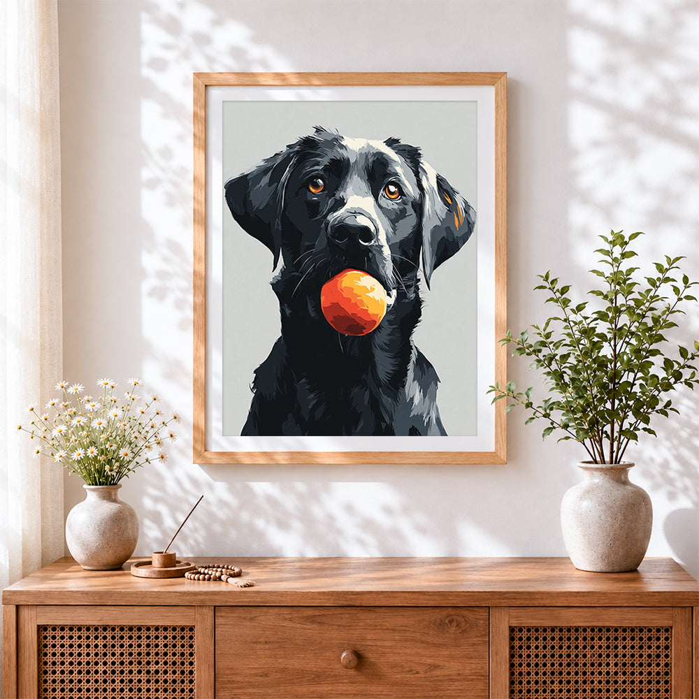 Finished black labrador with ball cross stitch artwork displayed