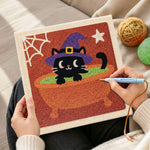 Creating handmade black witch cat in cauldron punch needle artwork
