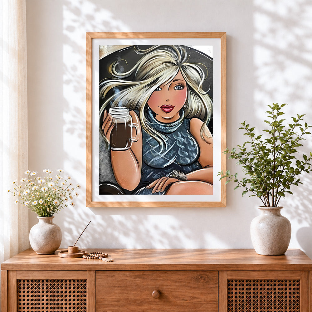 Finished blonde woman drinking coffee cross stitch artwork displayed