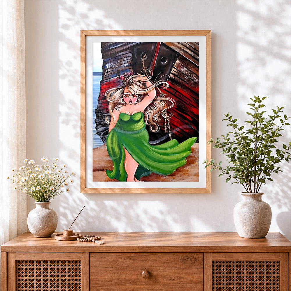 Finished blonde woman in green dress by boat cross stitch artwork displayed