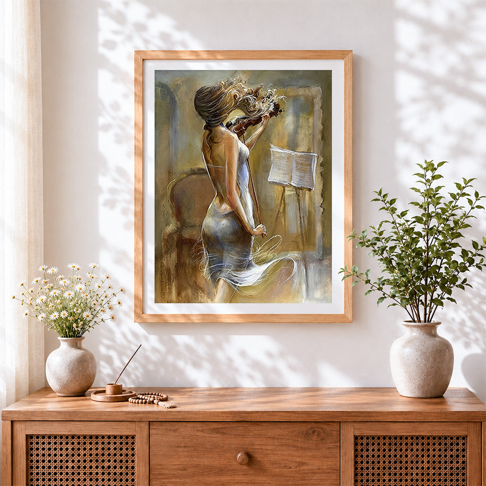 Finished blonde woman playing violin cross stitch artwork displayed