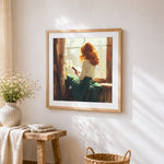 Blonde woman reading by the window cross stitch artwork displayed on wall as home decor