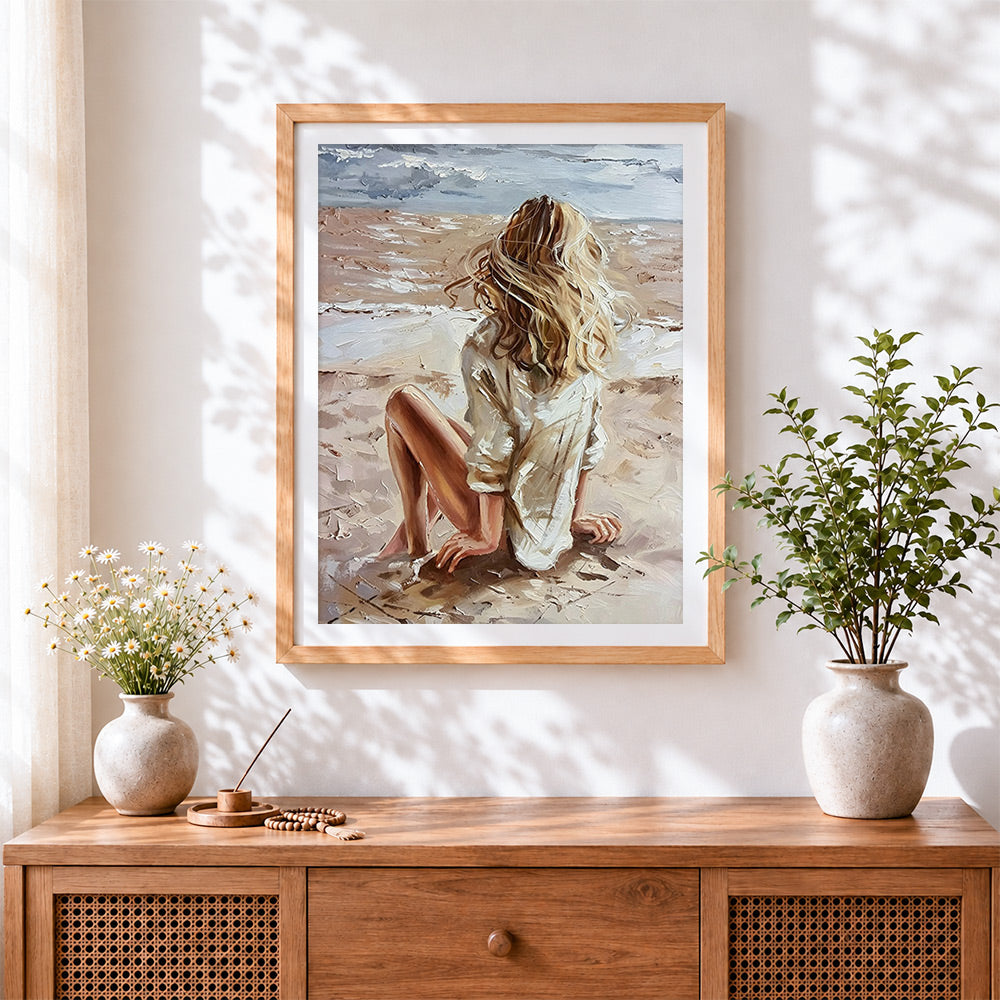 Finished blonde woman sitting on beach cross stitch artwork displayed