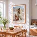 Blonde woman sitting on beach cross stitch artwork displayed on wall as home decor