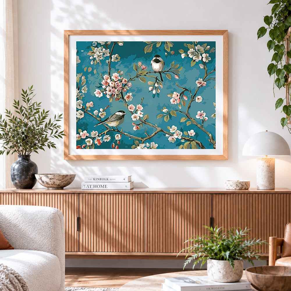 Finished blossoming cherry tree with birds cross stitch artwork displayed