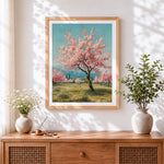 Finished blossoming pink trees in spring cross stitch artwork displayed