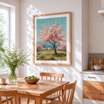 Blossoming pink trees in spring cross stitch artwork displayed on wall as home decor