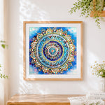 Finished blue and gold jewelled mandala cross stitch artwork displayed