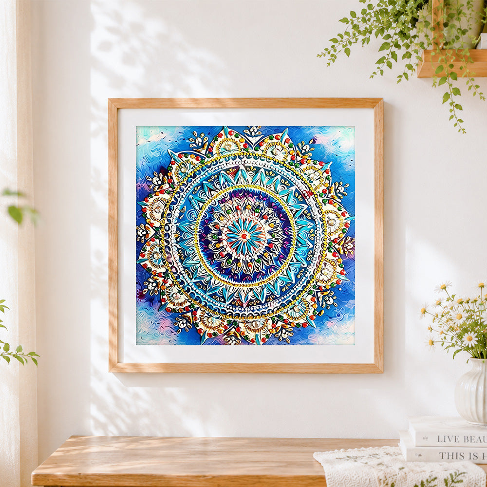 Finished blue and gold jewelled mandala cross stitch artwork displayed