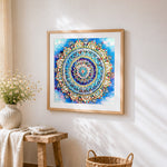 Blue and gold jewelled mandala cross stitch artwork displayed on wall as home decor