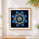 Finished blue and green dot mandala cross stitch artwork displayed