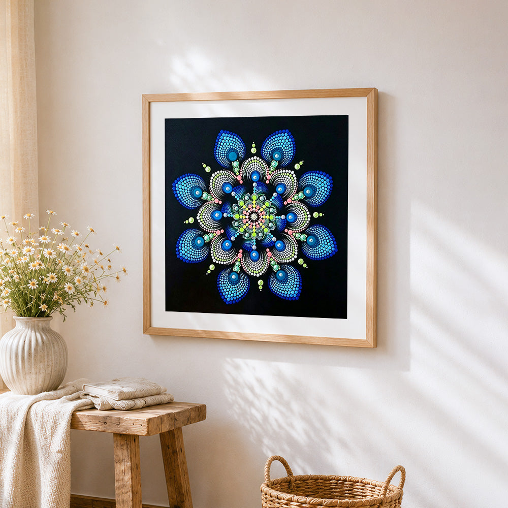 Blue and green dot mandala cross stitch artwork displayed on wall as home decor