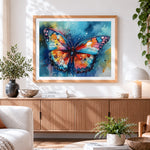 Finished blue and orange watercolour butterfly cross stitch artwork displayed
