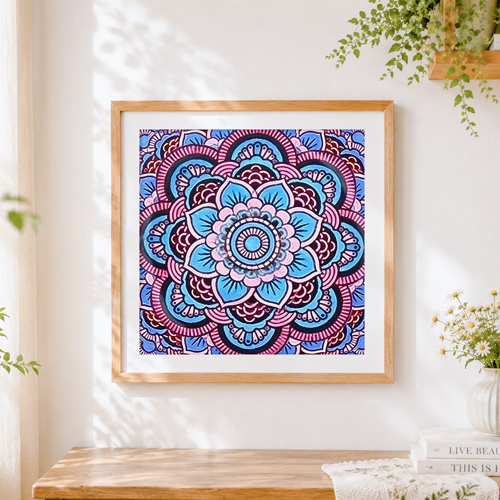 Finished blue and pink floral mandala cross stitch artwork displayed