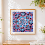 Finished blue and pink floral mandala cross stitch artwork displayed