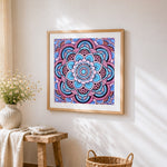 Blue and pink floral mandala cross stitch artwork displayed on wall as home decor