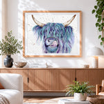Finished blue and purple watercolour highland cow cross stitch artwork displayed