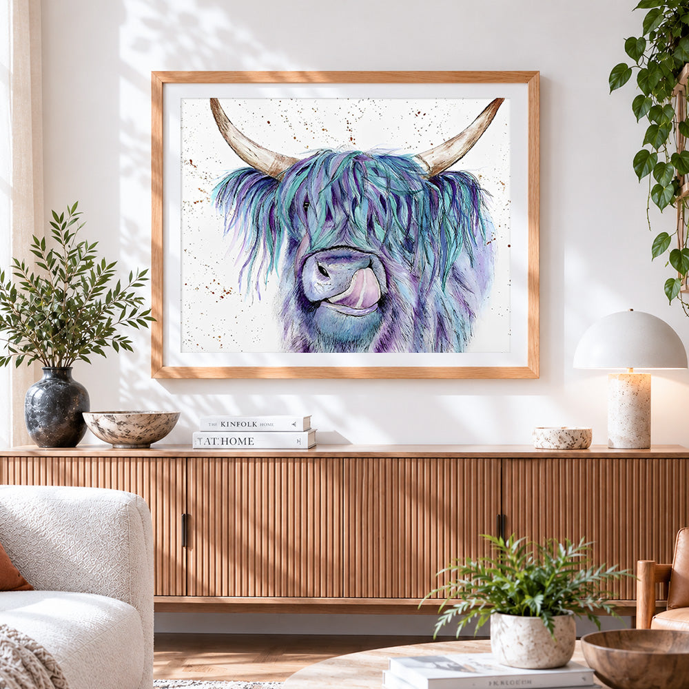 Finished blue and purple watercolour highland cow cross stitch artwork displayed
