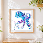 Finished blue and purple watercolour octopus cross stitch artwork displayed