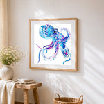 Blue and purple watercolour octopus cross stitch artwork displayed on wall as home decor