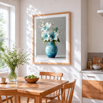 Blue and white lilies in a vase cross stitch artwork displayed on wall as home decor