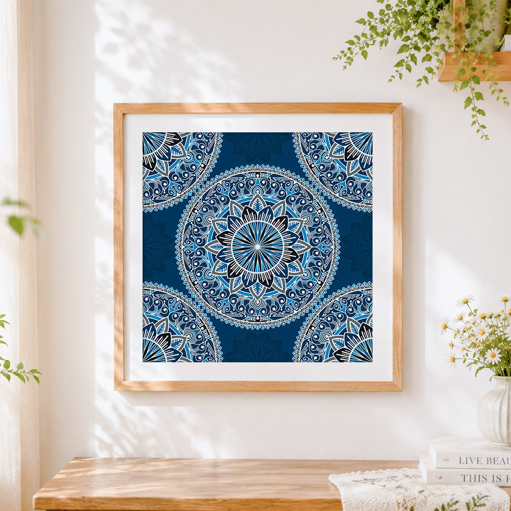 Finished blue and white patterned mandala cross stitch artwork displayed