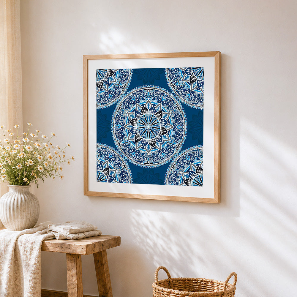 Blue and white patterned mandala cross stitch artwork displayed on wall as home decor