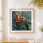 Finished blue and yellow macaws cross stitch artwork displayed
