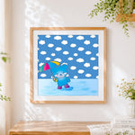Finished blue bear with umbrella in rain cross stitch artwork displayed