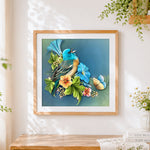 Finished blue bird with flowers cross stitch artwork displayed