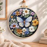 Blue butterfly in wildflower garden embroidery hoop wall art displayed as warm and cozy handmade home decor
