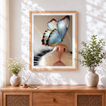 Finished blue butterfly on cat nose cross stitch artwork displayed