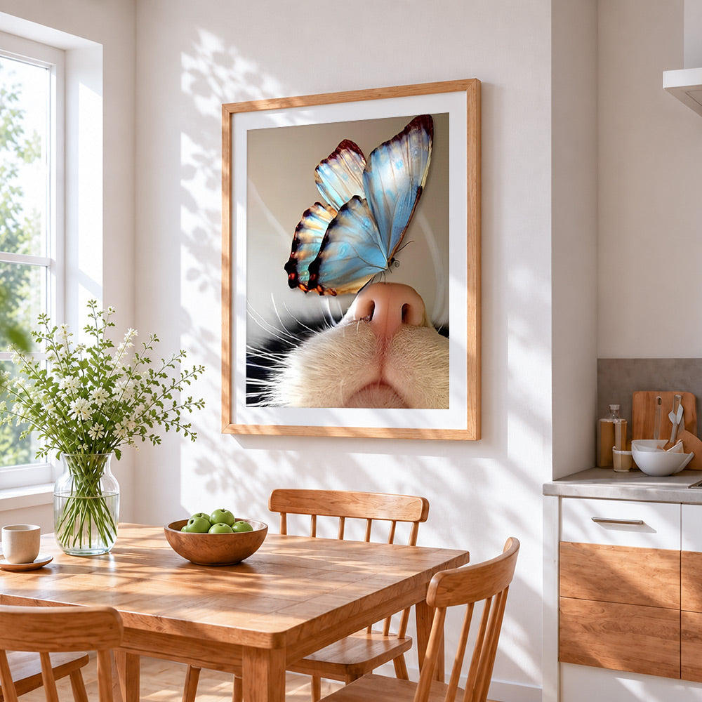 Blue butterfly on cat nose cross stitch artwork displayed on wall as home decor