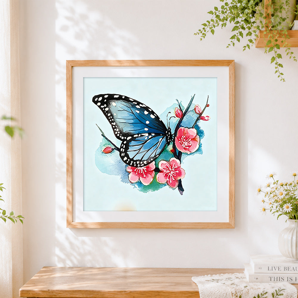 Finished blue butterfly with cherry blossoms cross stitch artwork displayed