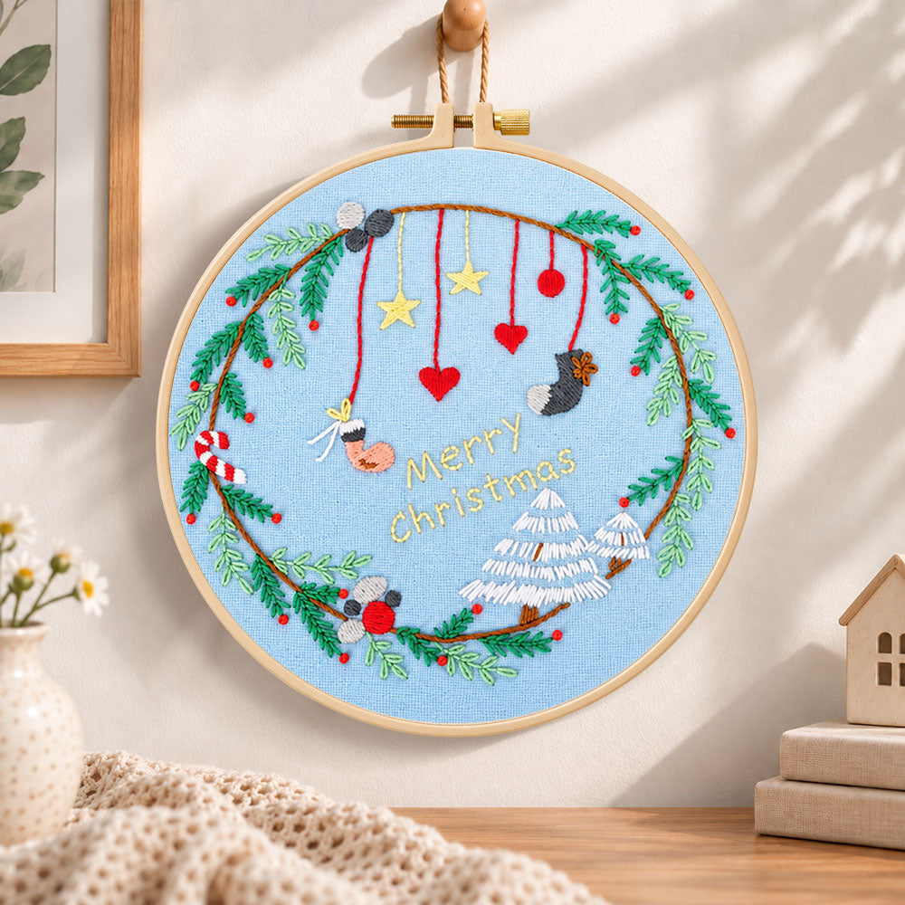 Blue christmas wreath embroidery hoop wall art displayed as warm and cosy handmade home decor