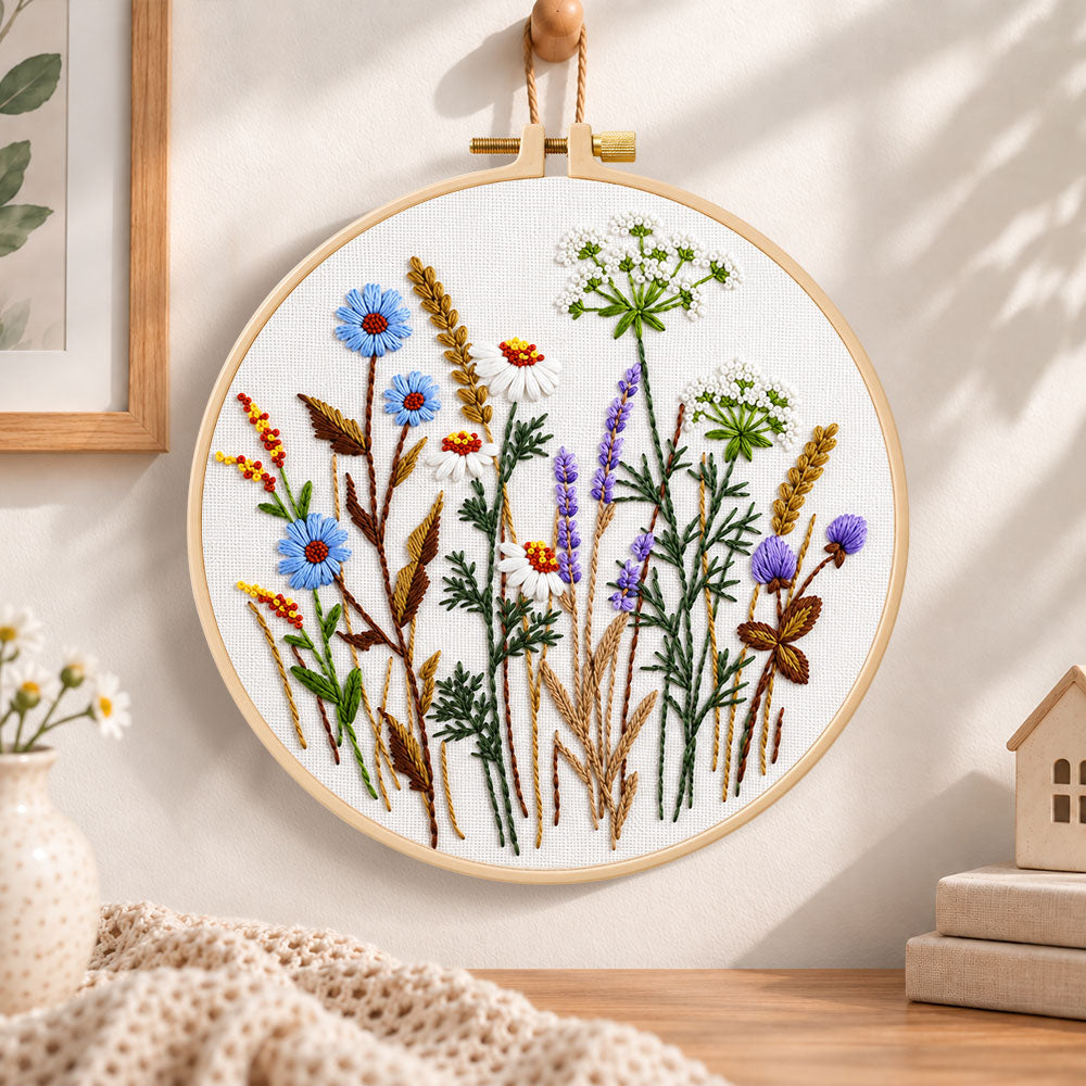 Blue cornflower meadow embroidery hoop wall art displayed as warm and cosy handmade home decor