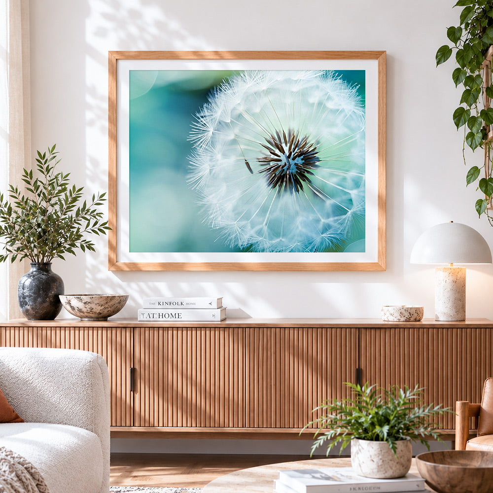 Finished blue dandelion cross stitch artwork displayed