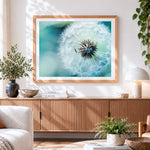 Finished blue dandelion cross stitch artwork displayed